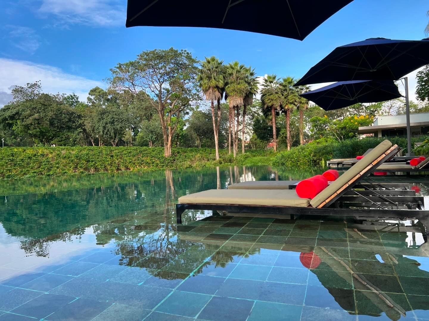 Sun loungers on an infinity pool of a safari lodge in Tanzania. 