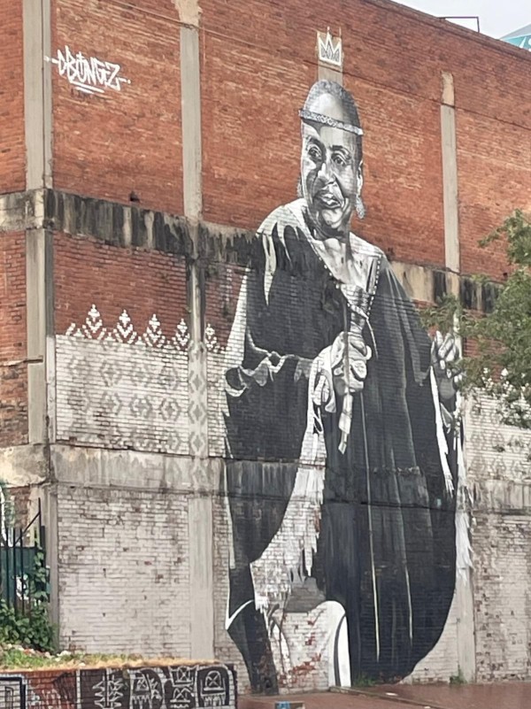 Large mural of a woman painted on a brick building in Maboneng, Johannesburg, South Africa.