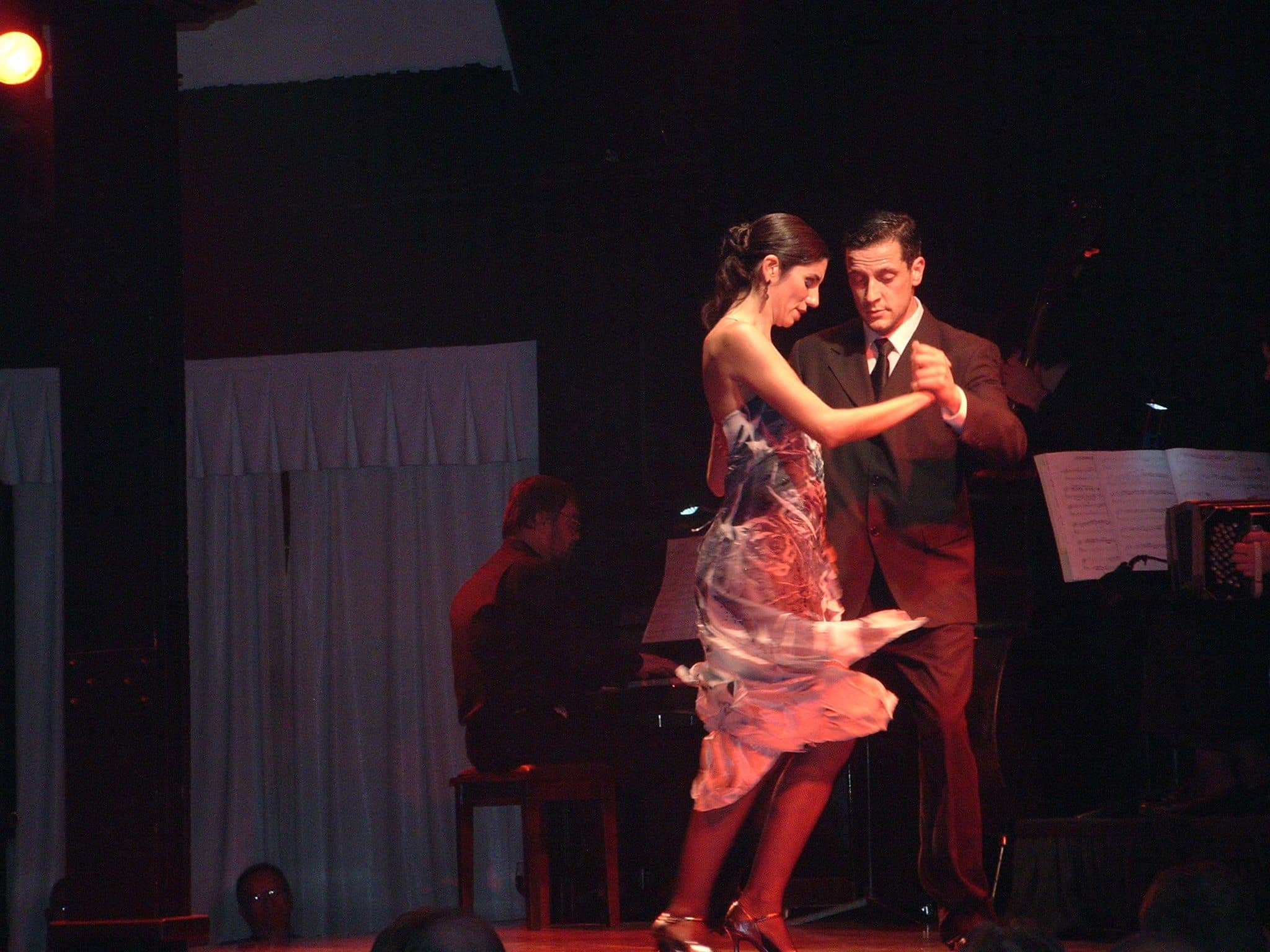 Tango dancers performing on stage in Buenos Aires.