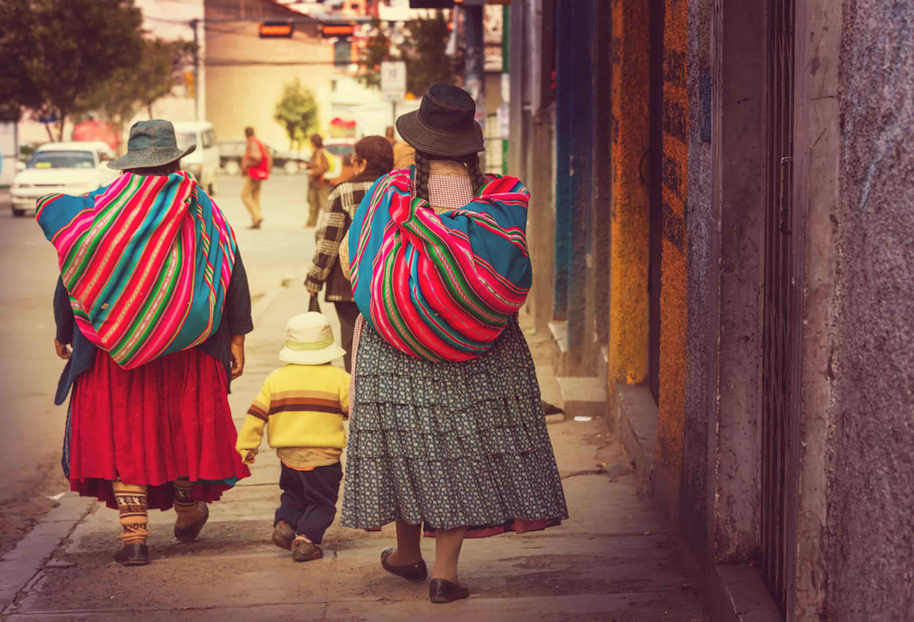 Two Cholita women in their traditional clothes walking on the sidewalk. Two Cholita women in their traditional clothes walking on the sidewalk.