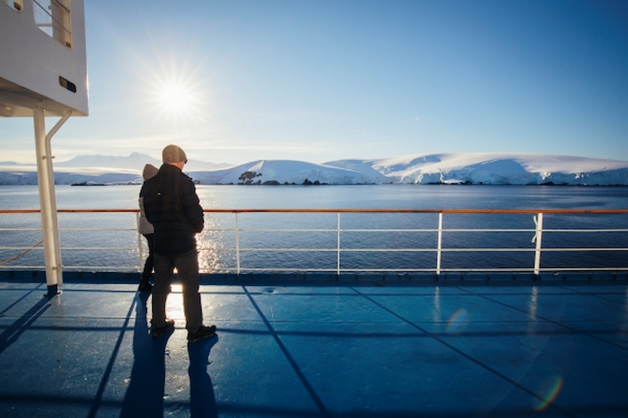 Guest standing on the deck of an expedition ship