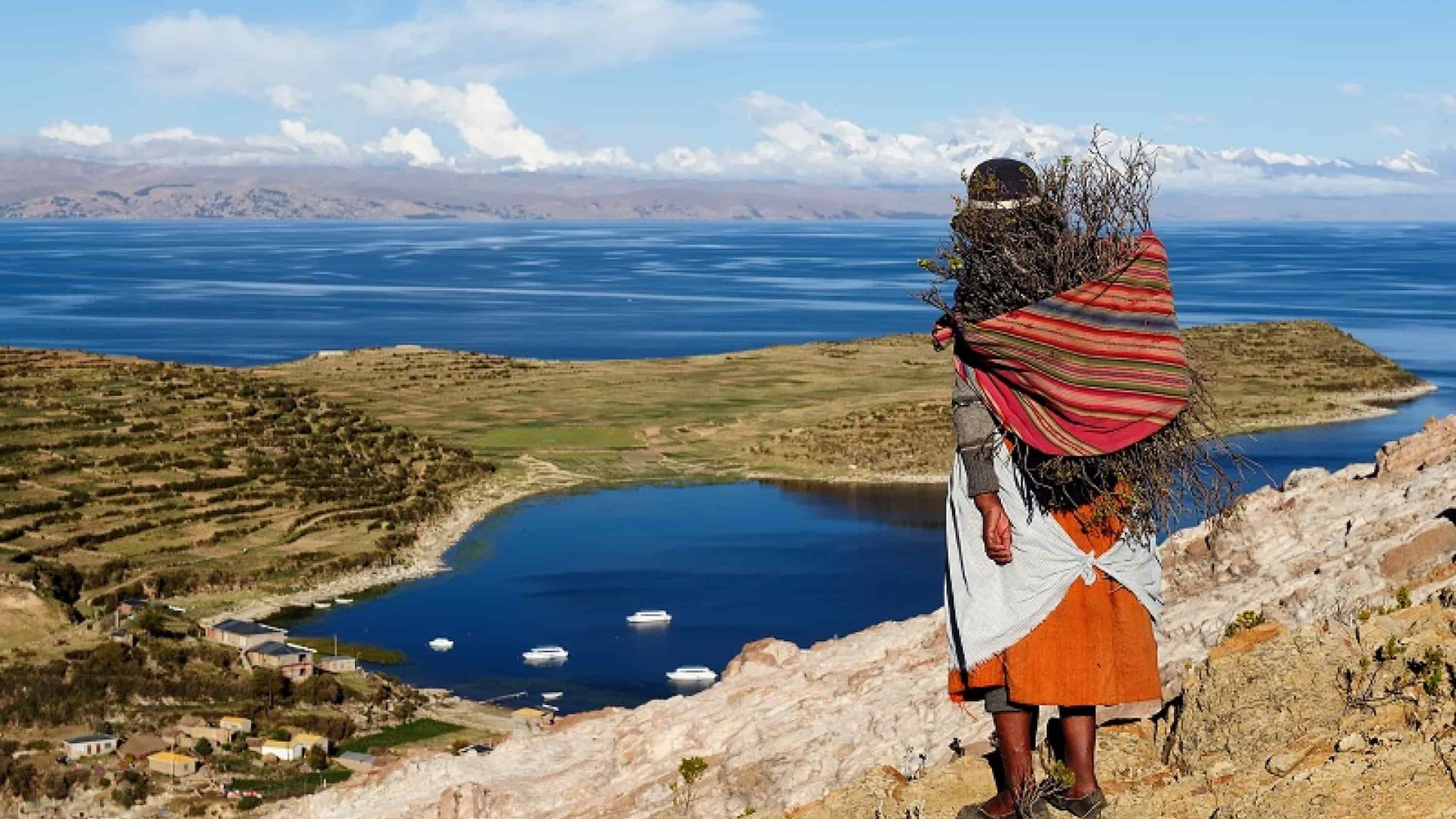 A person on a hill overlooking Lake Titicaca. A person on a hill overlooking Lake Titicaca.
