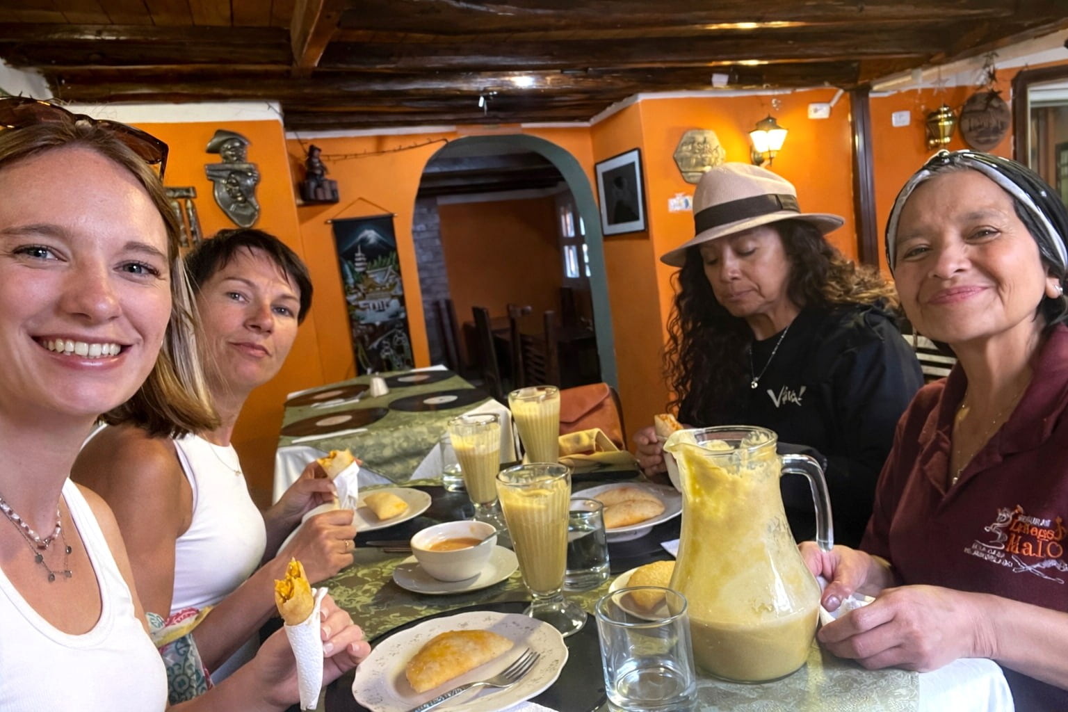Six Senses Tour guests in Quito, Ecuador, enjoying handmade empanadas at a local restaurant