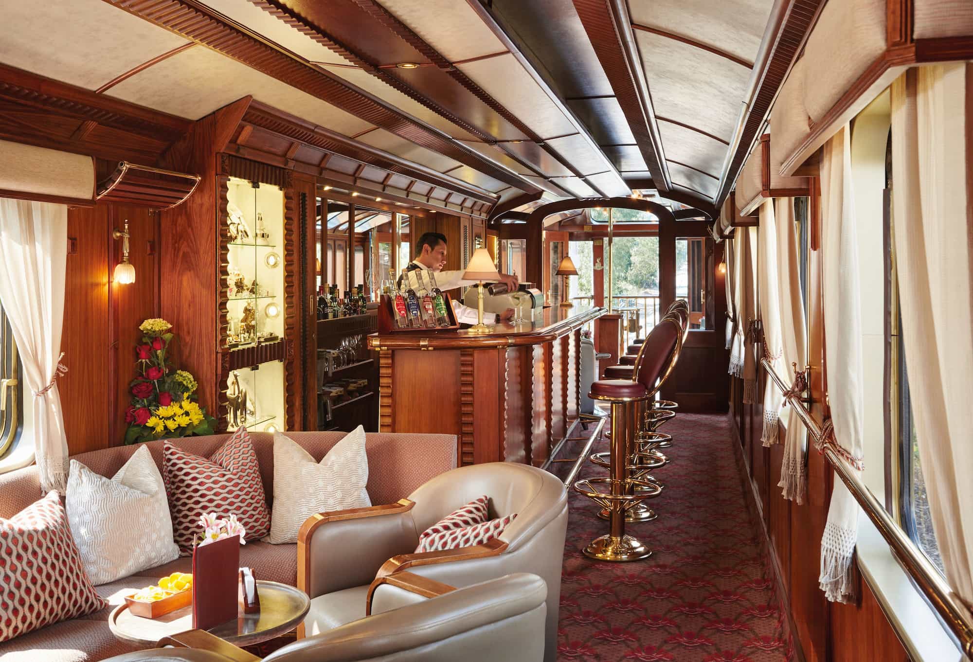 Interior of the Hiram Bingham luxury train to Machu Picchu, with bar, seating area, and elegant wood-panelled design. Interior of the Hiram Bingham luxury train to Machu Picchu, with bar, seating area, and elegant wood-panelled design.