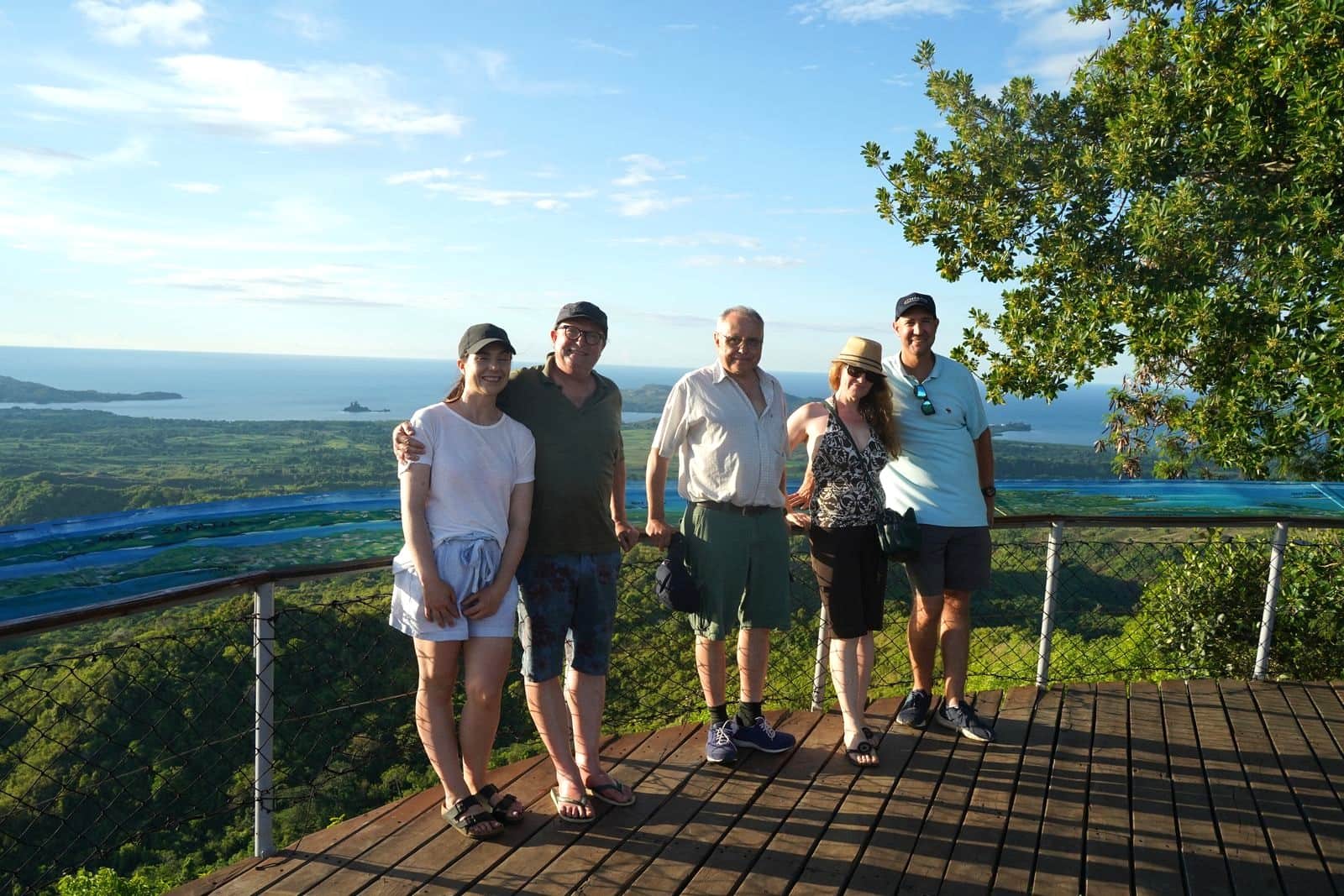 Group of five travellers at a scenic lookout above a coastal bay, northern Madagascar