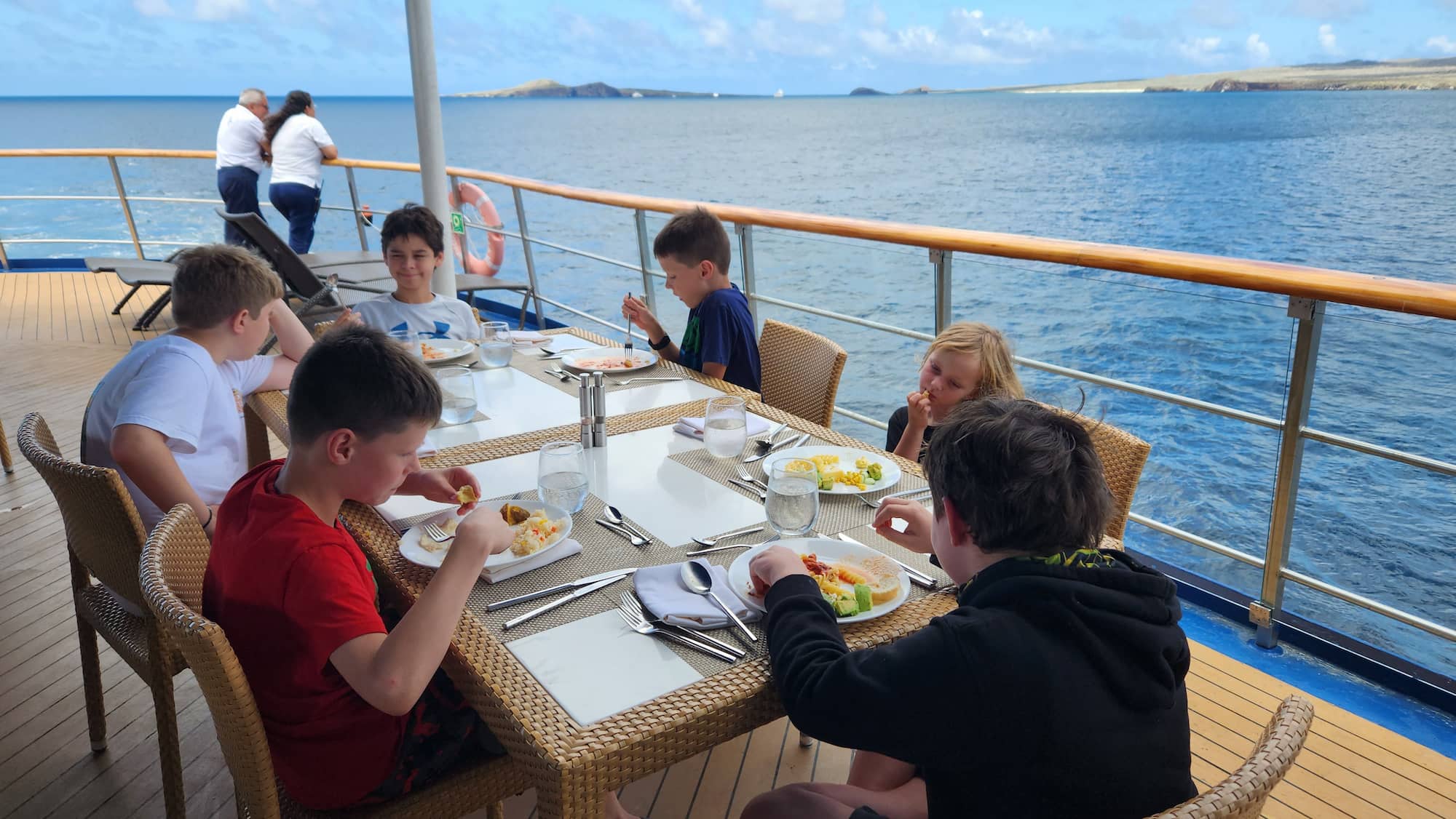 Kids enjoying a meal aboard a Galápagos expedition vessel