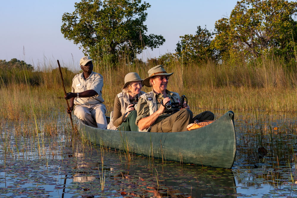 Guests enjoying a peaceful mokoro ride through the tranquil waterways of Botswana.
