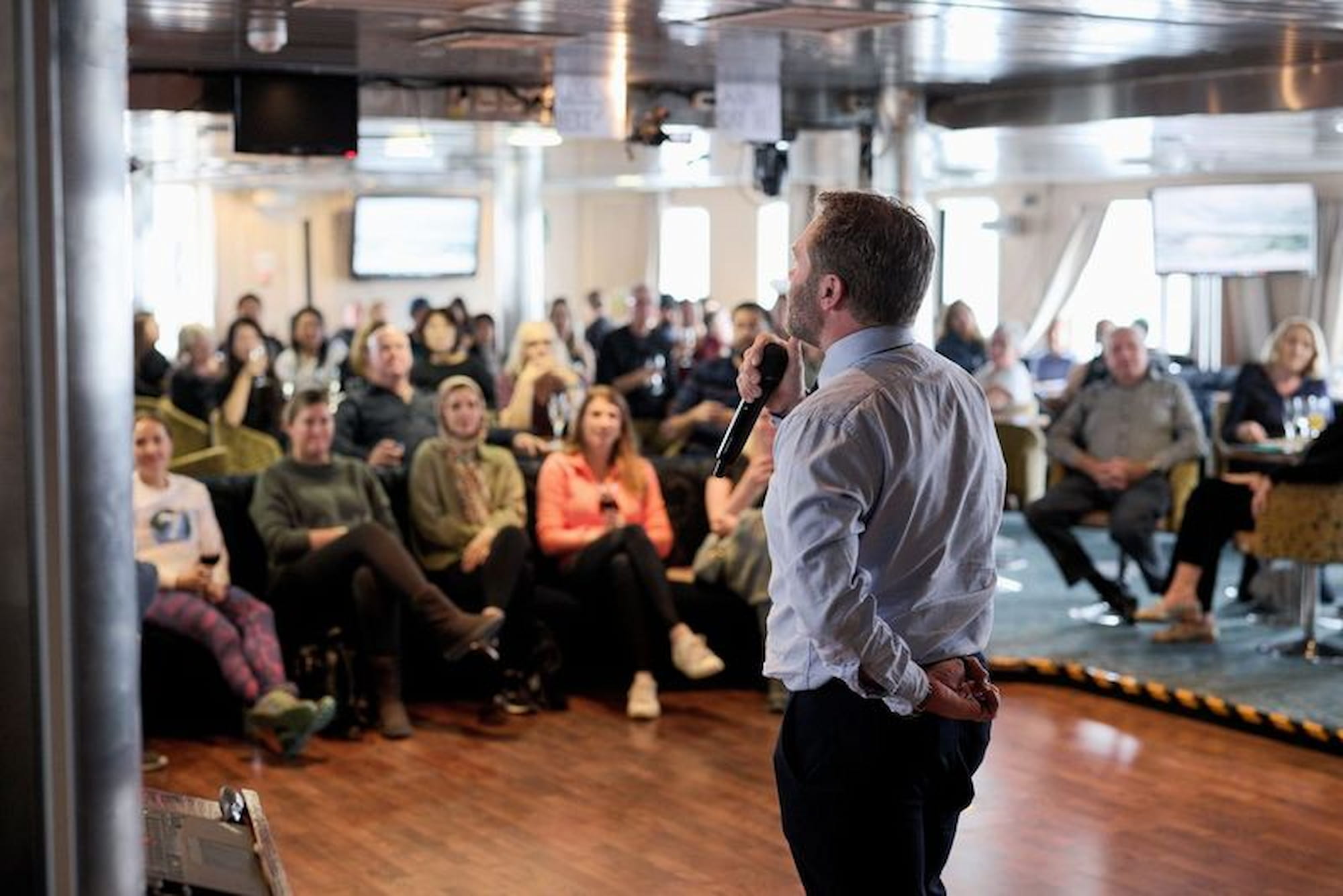 Expedition ship passengers attending an expert-led lecture onboard lecture during the Drake Passage crossing on an Antarctica cruise.