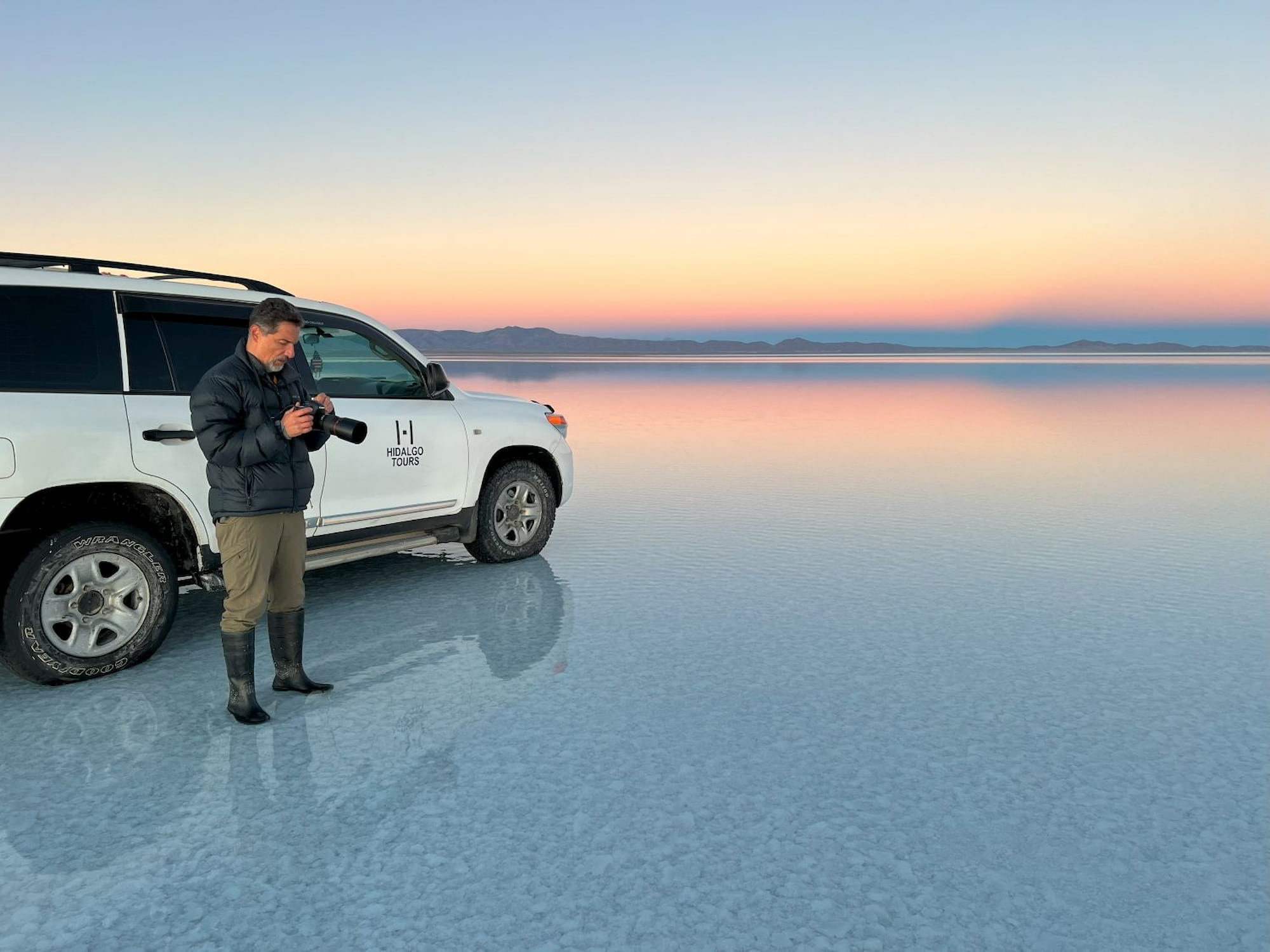 Mirror reflection on the flooded Salar de Uyuni salt flats at sunset, Bolivia