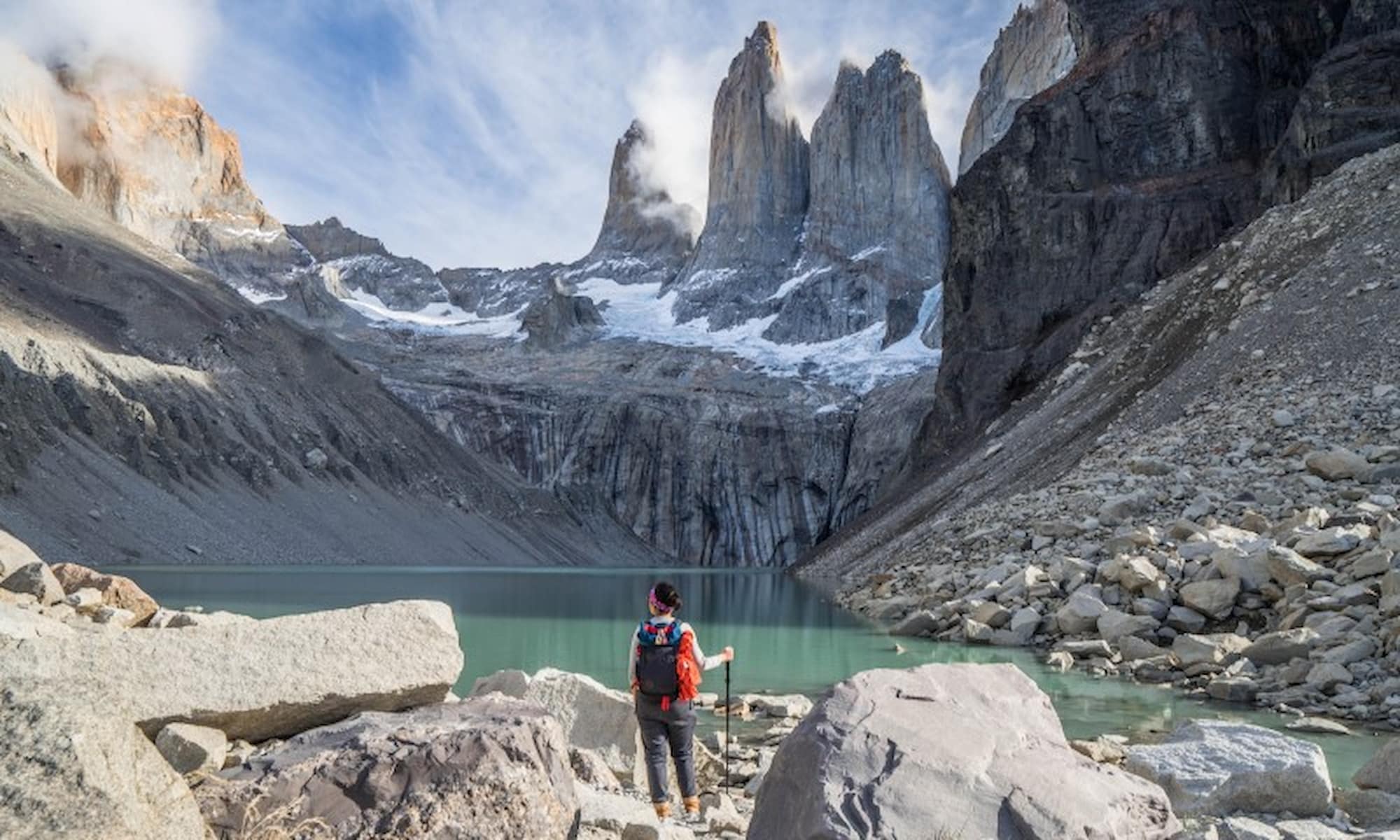 A woman takes a scenic hike to the breathtaking mountains of Patagonia