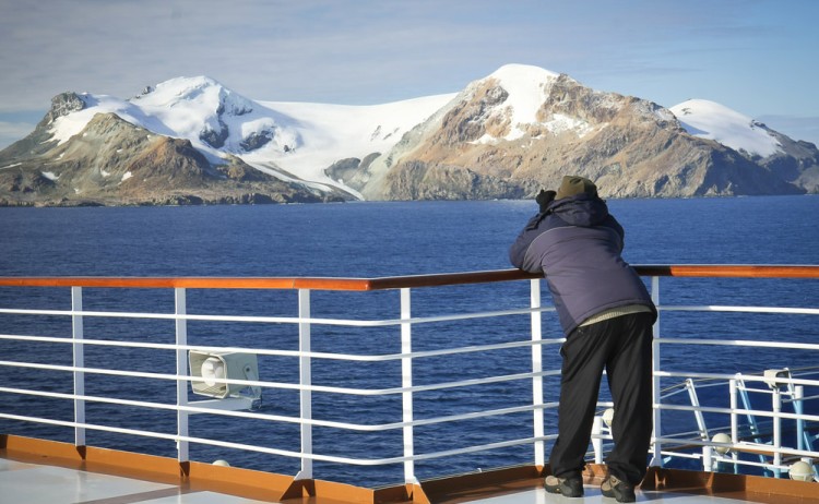 Guest on observation deck taking the Antarctics dramatic landscape