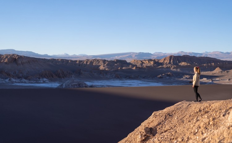 Atacama Desert tour woman standing on the edge of Moon valley Chile