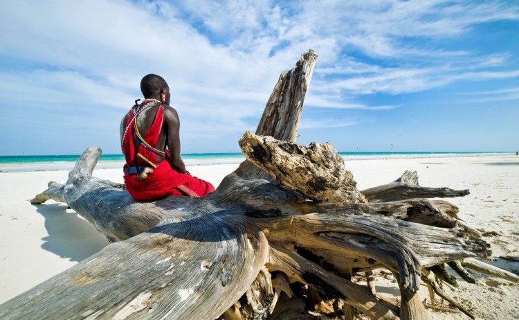 Maasai sitting by the ocean on the beach