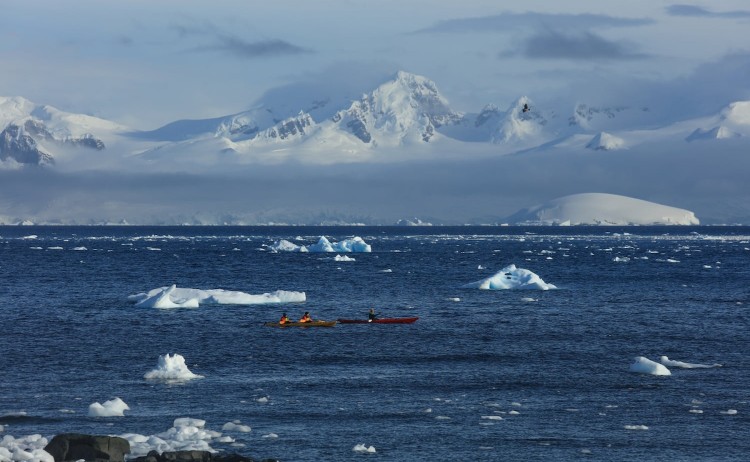 Crossing the Antarctic Circle kayaking activity in the icy waters