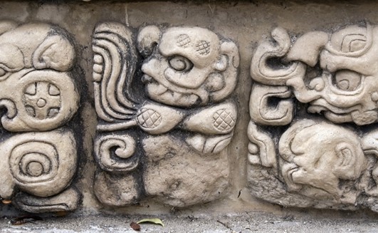Detail of ancient Mayan Gods and demons at Copan Honduras st 12