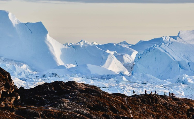 Greenland Disko Bay guest on guided walk near the towering glacier