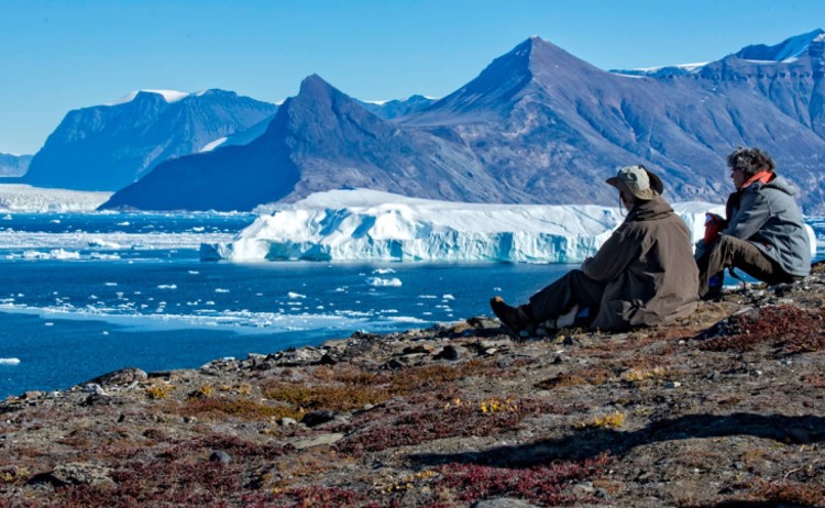 Into the Northwest Passage guest taking a moment in the Greenlands landscape