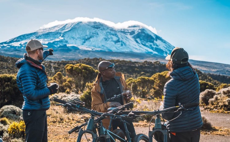 Riding Giants guest taking a break while admiring the breathaking mountain landscape