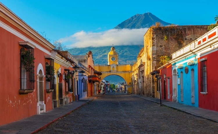 Signature Guatemala tours cityscape of the main street and yellow Santa Catalina arch in the historic city center