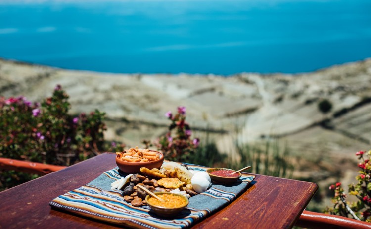 Sun Island Ecolodge food set against the rugged cliffs and deep blue sea
