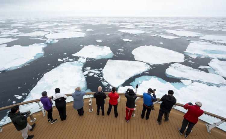 Ultimate Arctic Odyssey guests on the ship deck observing the pack of ice floes