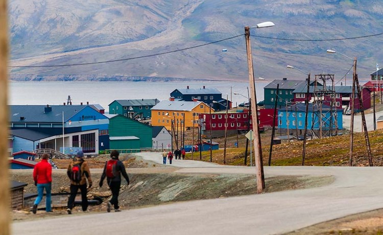 Ultimate Arctic Odyssey tourists walking along road ongyearbyen