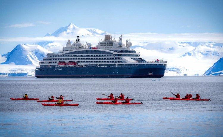 Unexplored Antarctica between Two Continents two penguins in Antarctica guest on Kayaking excursion