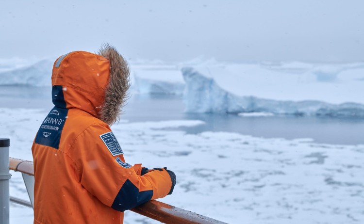 French Southern Lands guest on ship deck witnessing the breathaking ice landscape