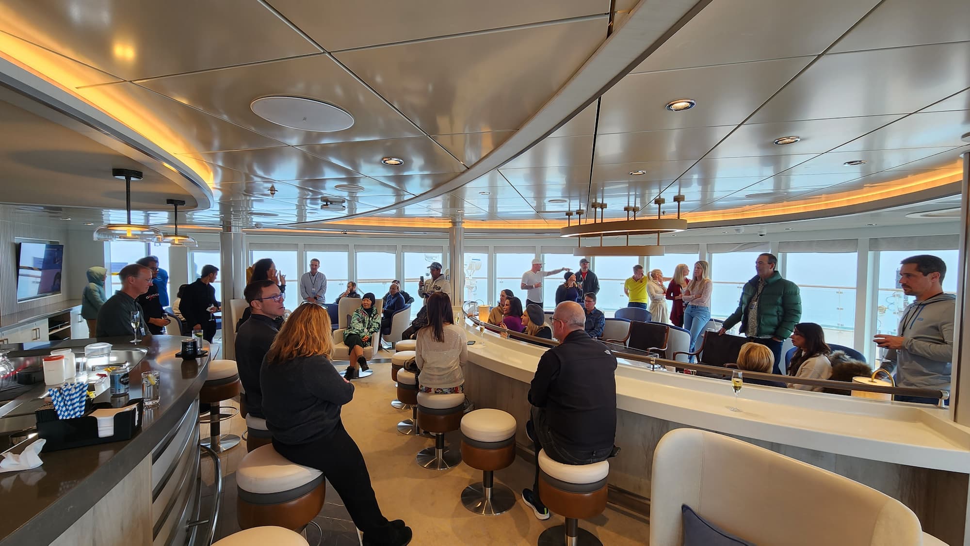 Antarctica expedition cruise ship passengers socialising in common area.