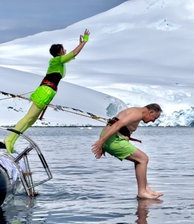 Tara Sutherland and John Key doing the polar plunge in bright green outfits