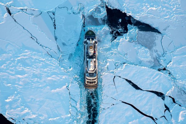 Aerial shot of cruise ship surrounded by ice