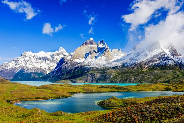 Beautiful Patagonia landscape of Andes mountain range, winding road and lake at 