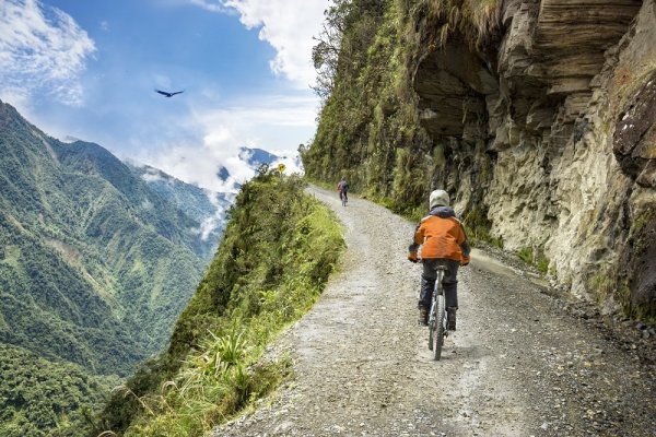 Bike tourists riding on the "road of death" downhill track, Bolivia