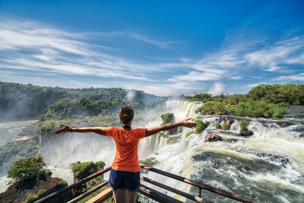 Tourist in Argentina on top of waterfall