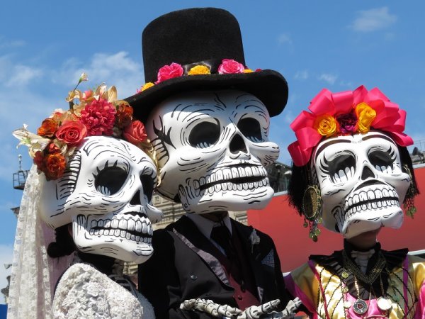 Day of the Dead participants with death masks