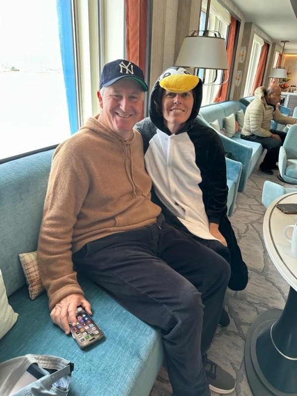 Sir John Key and Tara (in a penguin onesie) onboard the Ocean Albatros