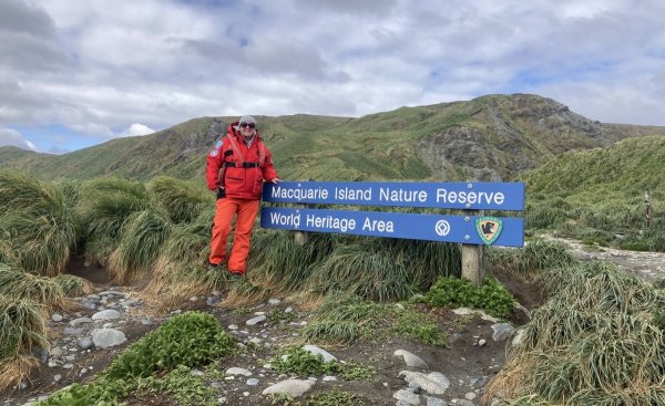 Emma standing next to Macquarie Island sign