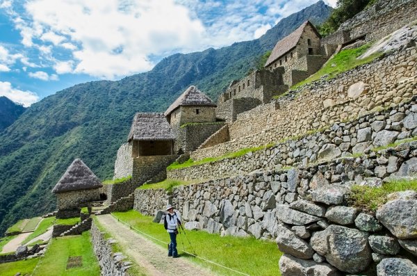 Tourist walking in Machu Picchu ruins