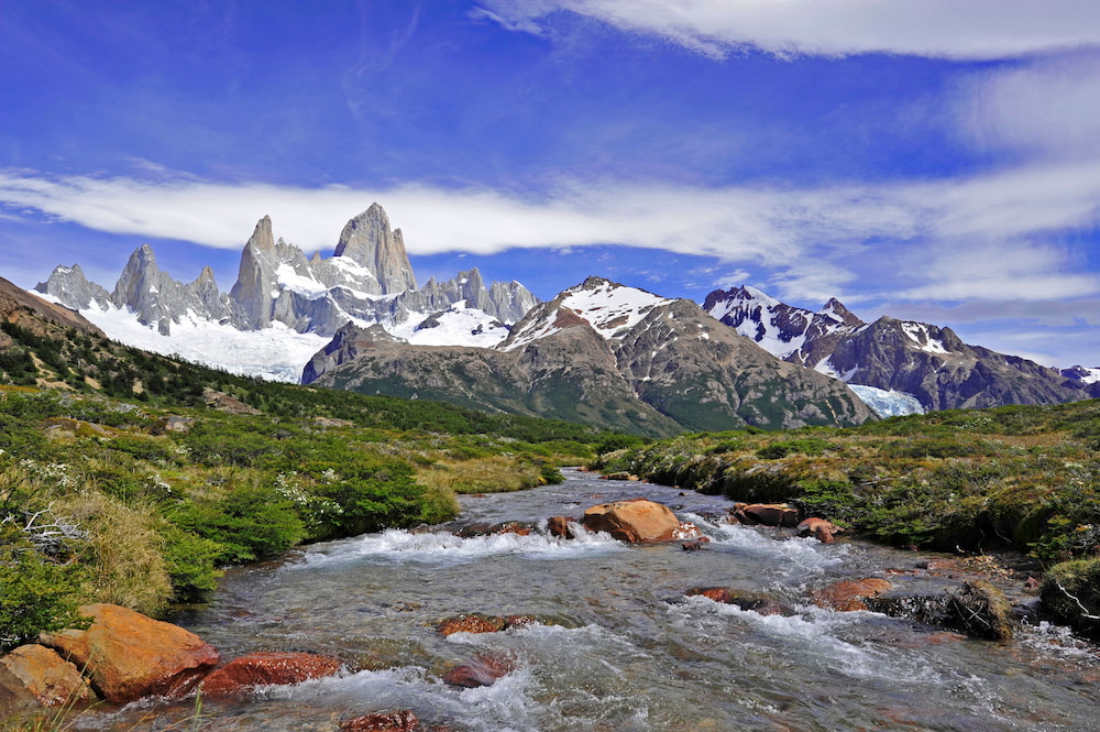 Dramatic peaks of Mount Fitz Roy with river in the foreground in Patagonia.