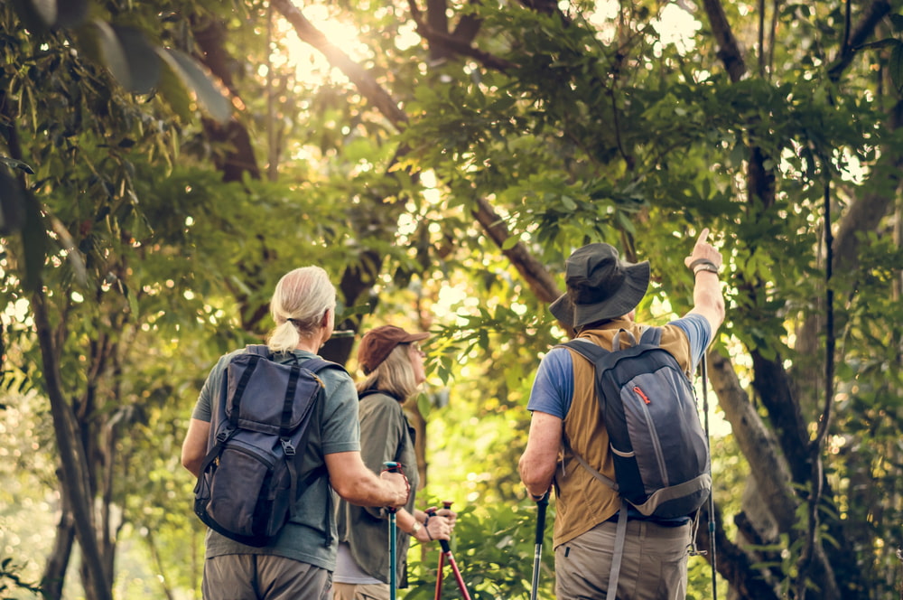 Tourist and guide on trek to Amazon rainforest.