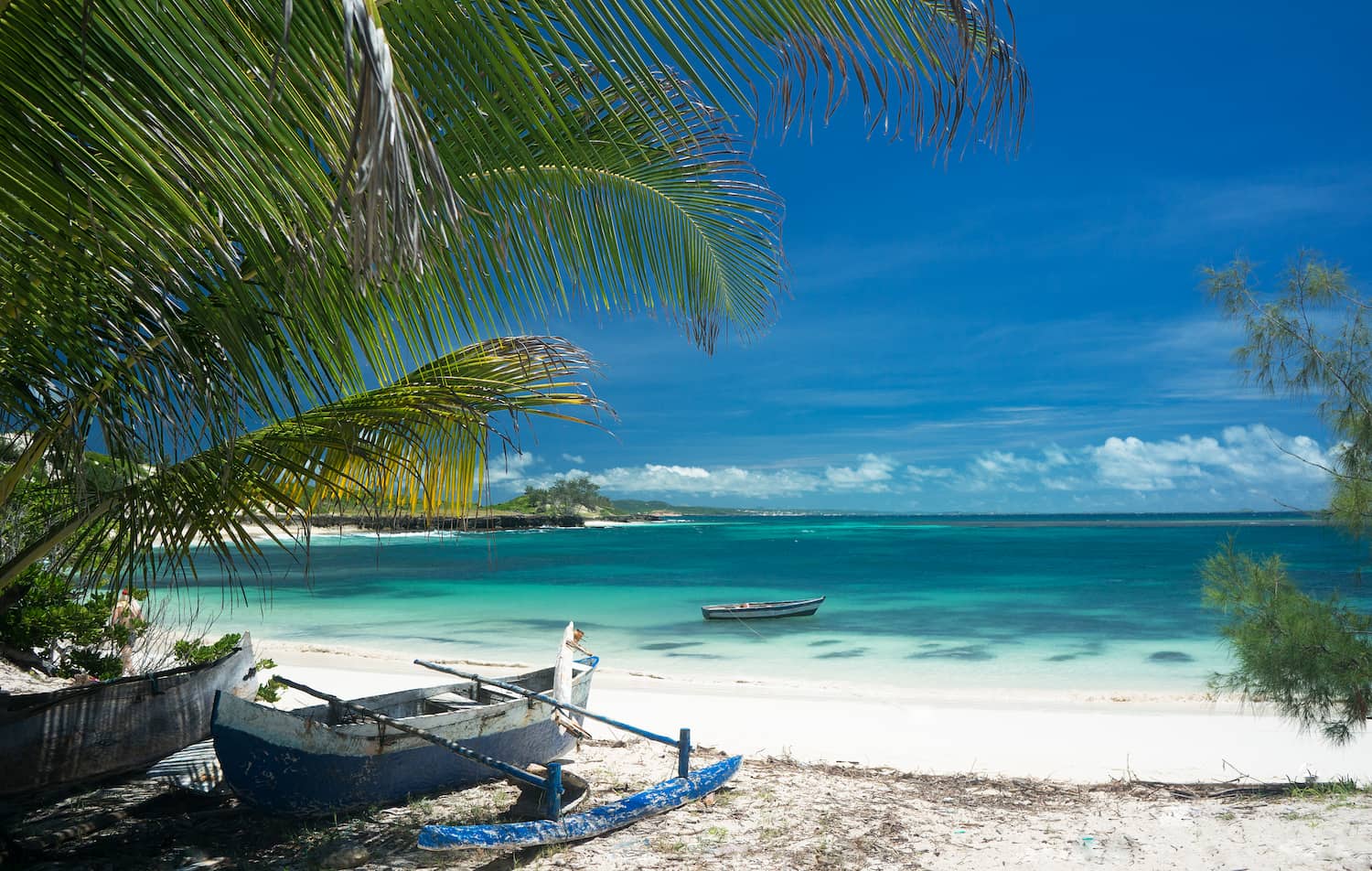 Traditional canoes on a sandy beach in Nosy Be, Madagascar