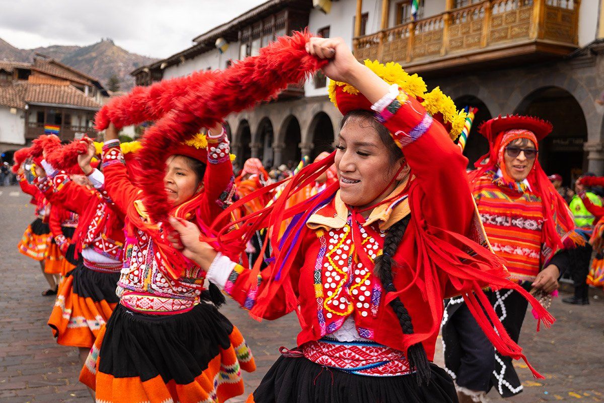 Dancers in bright traditional costumes perform during a festival in Cusco in August