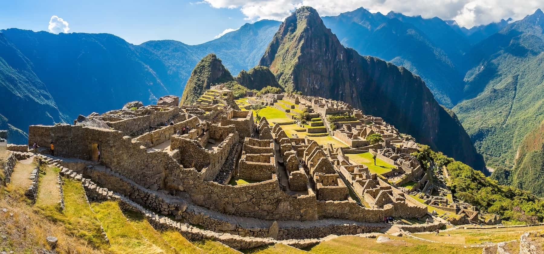 Machu Picchu Inca citadel in Peru in dry season, with blue sky and green terraces