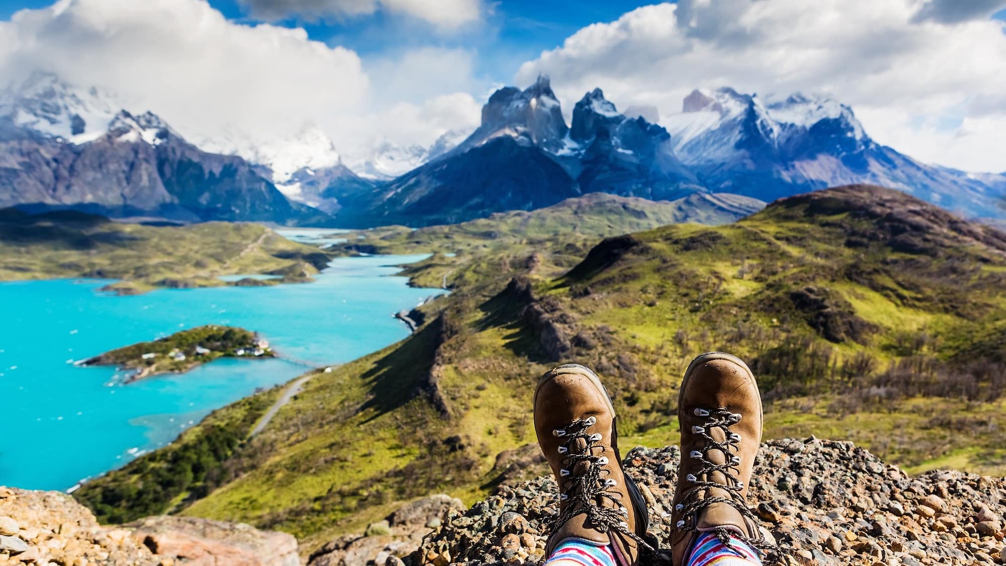 A panoramic view of Patagonia’s rugged mountain trails overlooking turquoise lakes
