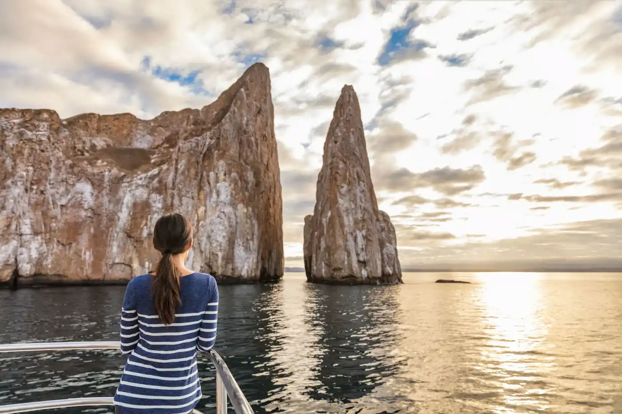 Woman enjoying the view of Kicker Rock, San Cristóbal Island