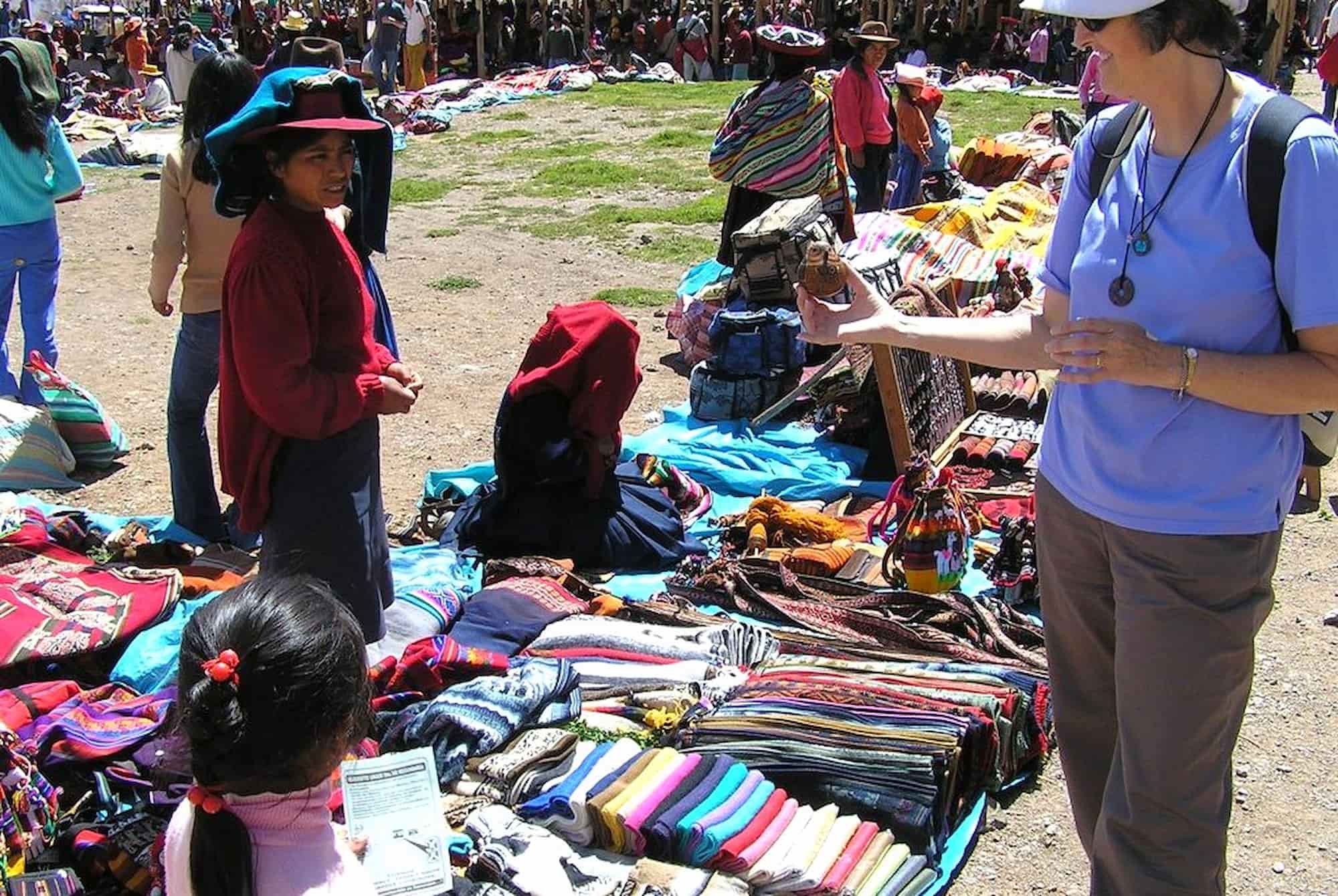 Woman selling colourful textile to tourist. Woman selling colourful textile to tourist.