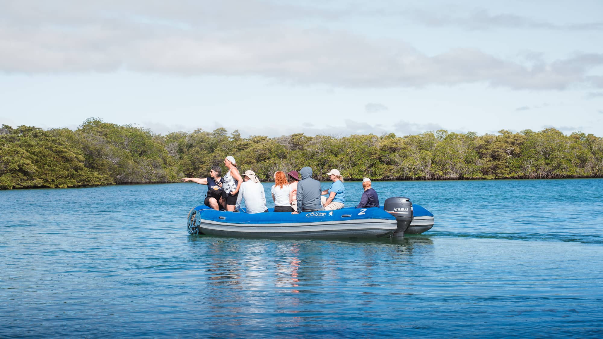 Guests in a dinghy on the lookout for wildlife, Galapagos Islands, Ecuador.