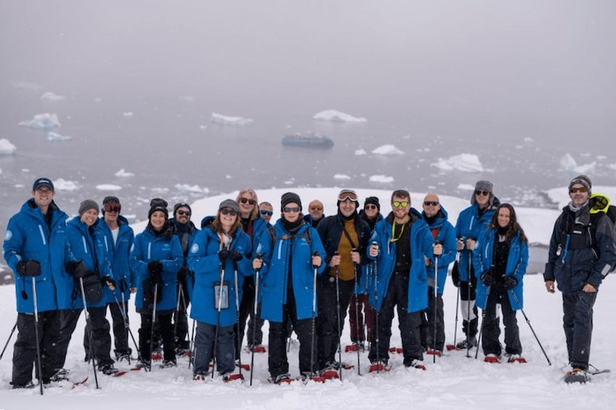 Guests gather for a group photo after an unforgettable snowshoe hike in Antarctica.