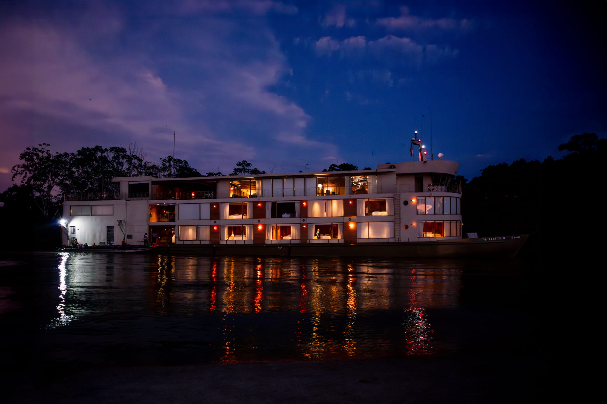 Small river cruise ship moored on an Amazon tributary at night, Peruvian Amazon