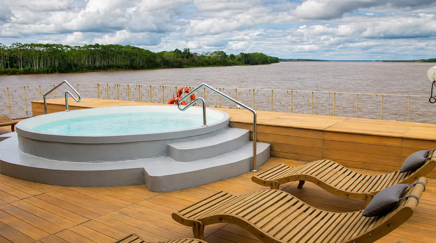 Cabin with panoramic river views aboard the Delfin III river cruise ship, Peruvian Amazon.
